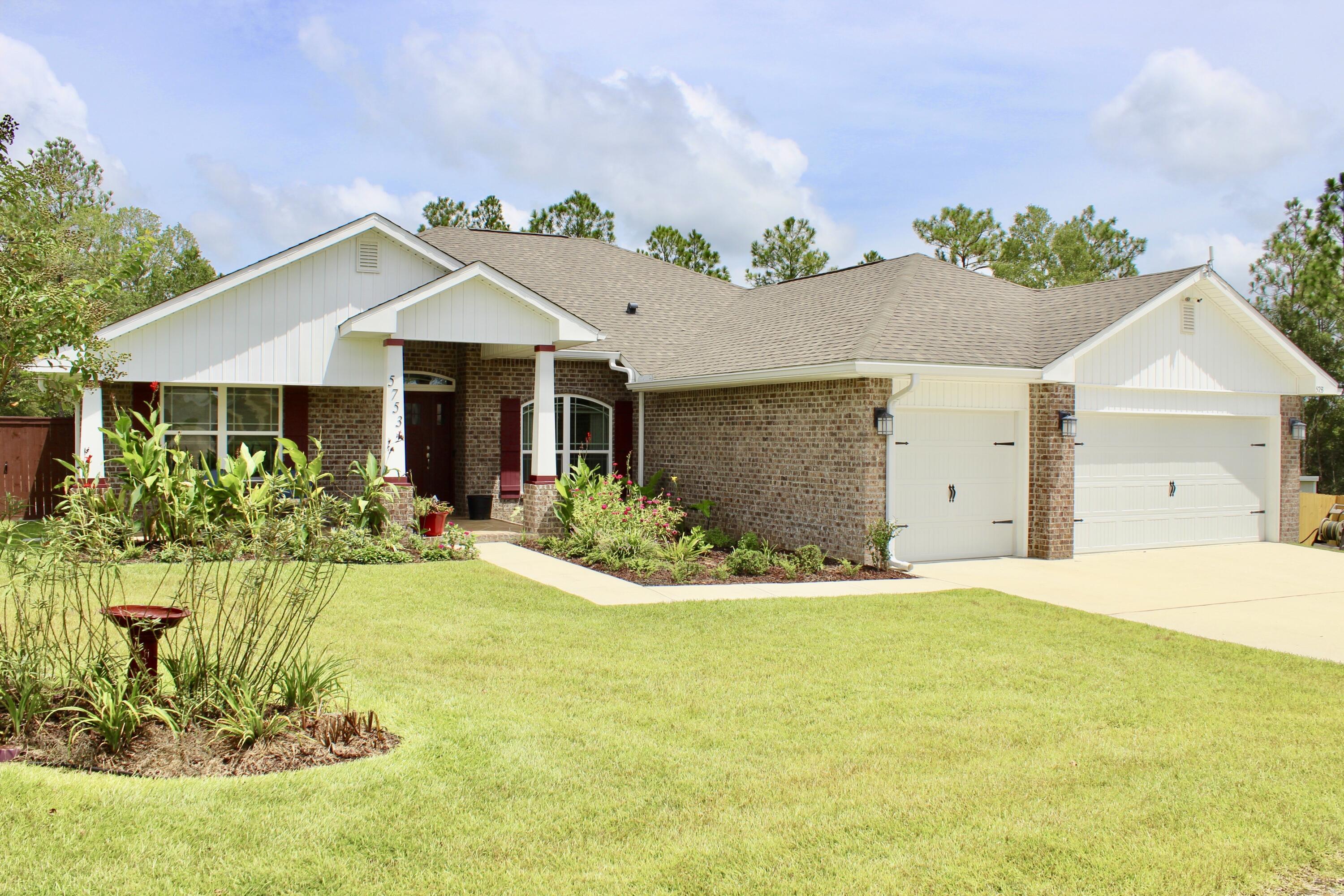 5753 Marigold Loop Crestview, FL 32539 - Photo 3 of 51 a front view of a house with a yard