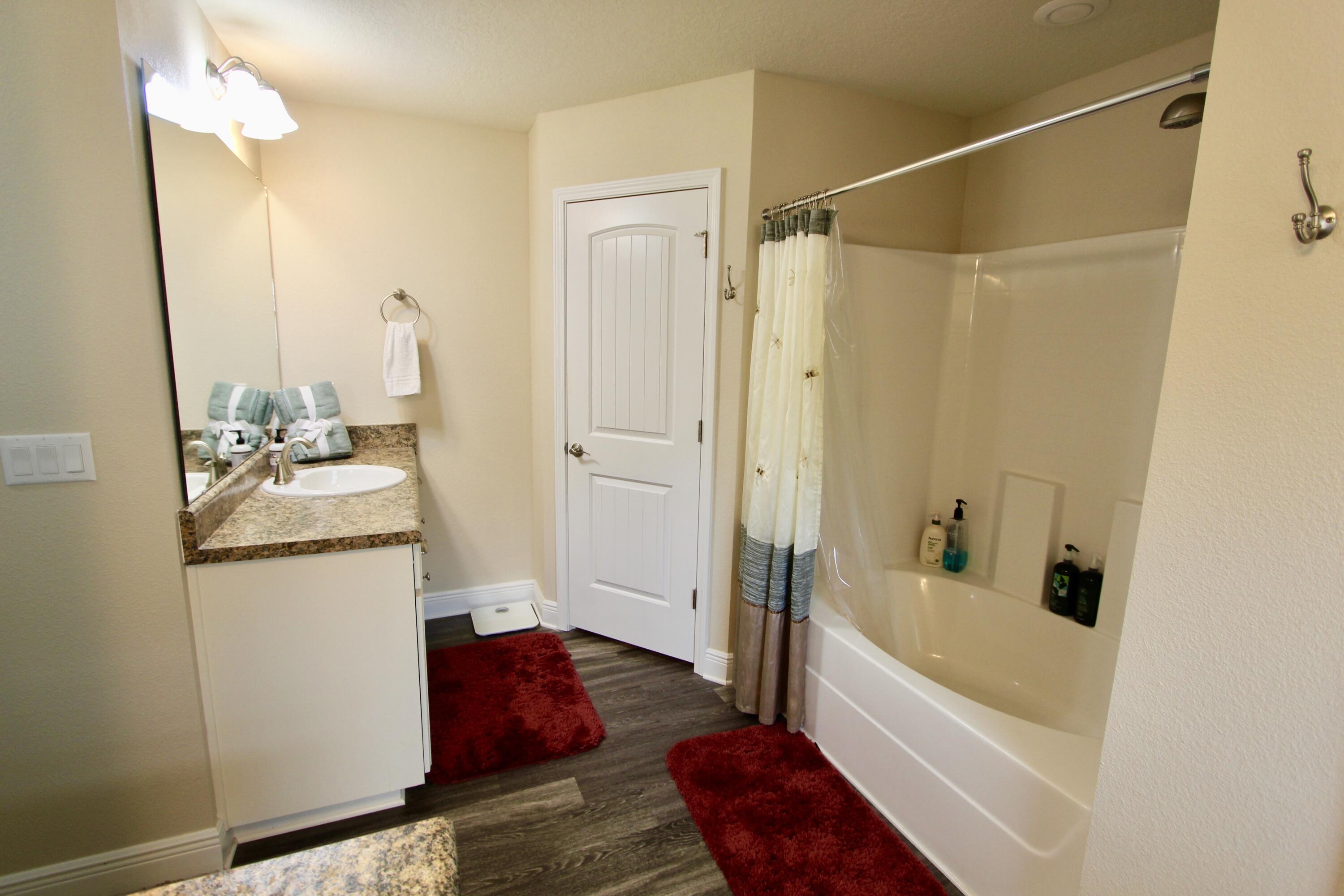5753 Marigold Loop Crestview, FL 32539 - Photo 34 of 51 a bathroom with a tub shower sink and vanity
