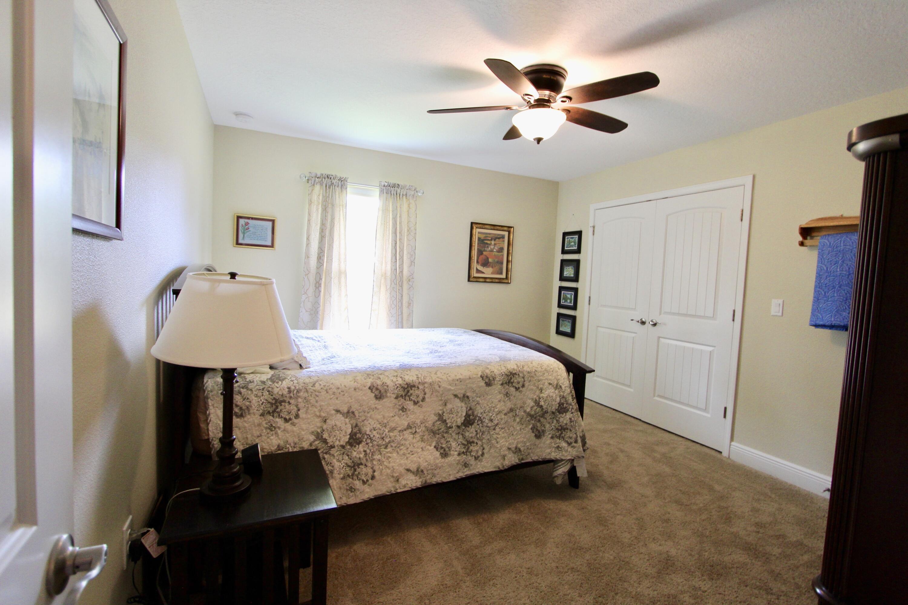 5753 Marigold Loop Crestview, FL 32539 - Photo 36 of 51 a bedroom with a bed and a table in it