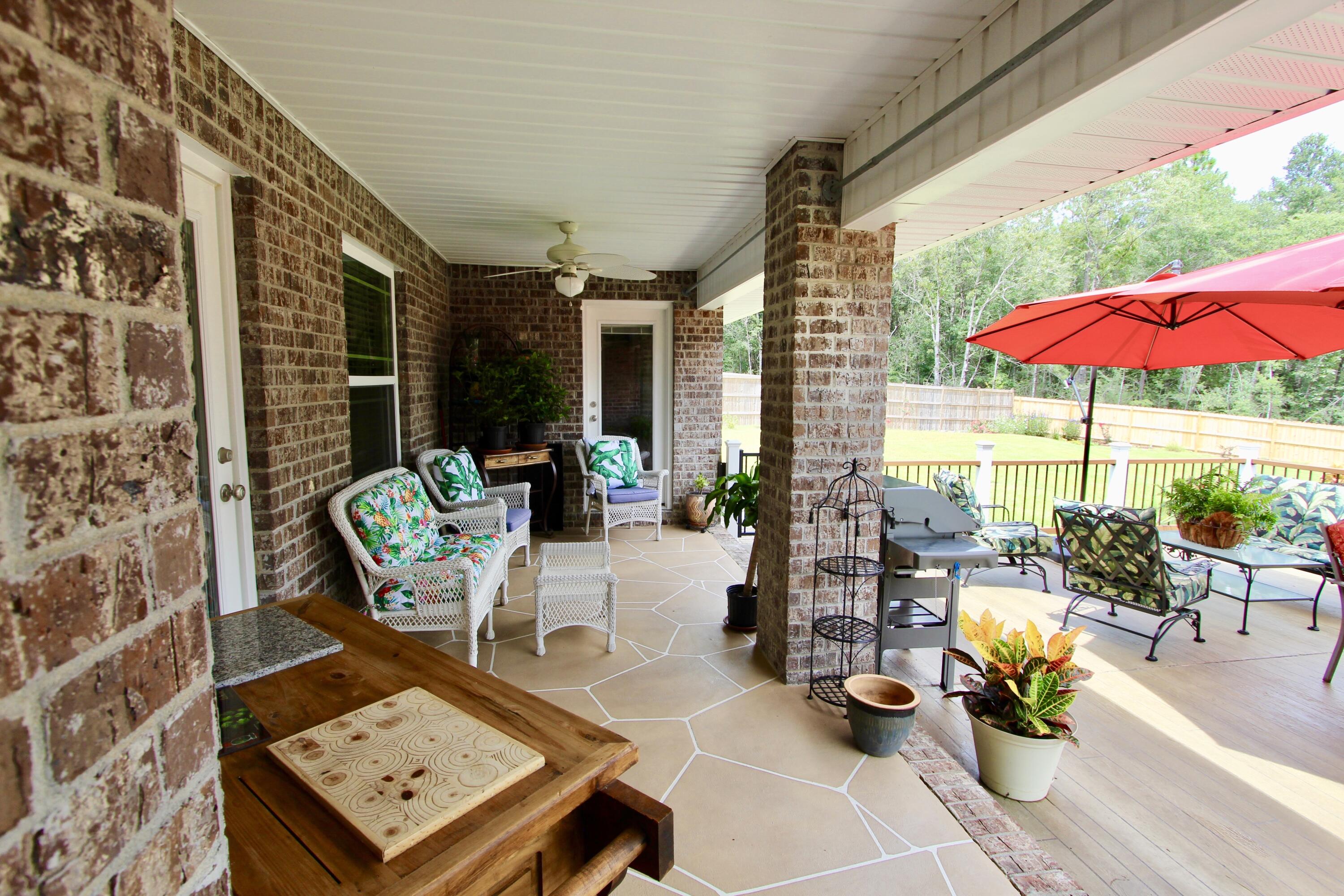 5753 Marigold Loop Crestview, FL 32539 - Photo 45 of 51 a view of a patio with chairs and table potted plants