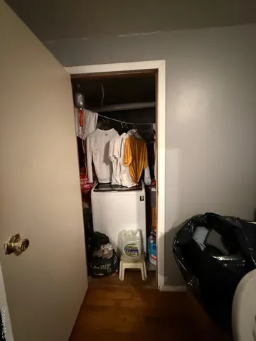 a white toilet sitting next to a bathroom sink and a mirror