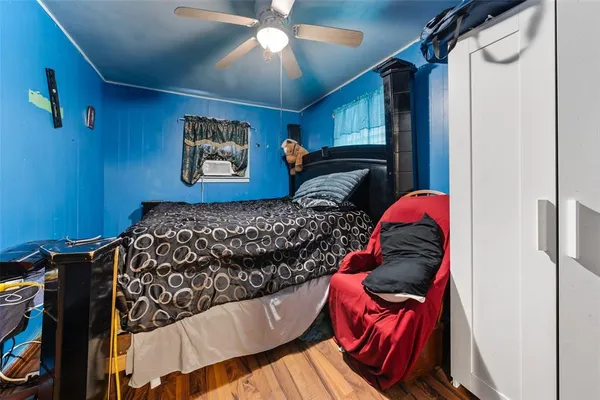 a bedroom with a bed and a painting on the wall