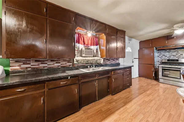 a kitchen with stainless steel appliances granite countertop a sink and cabinets