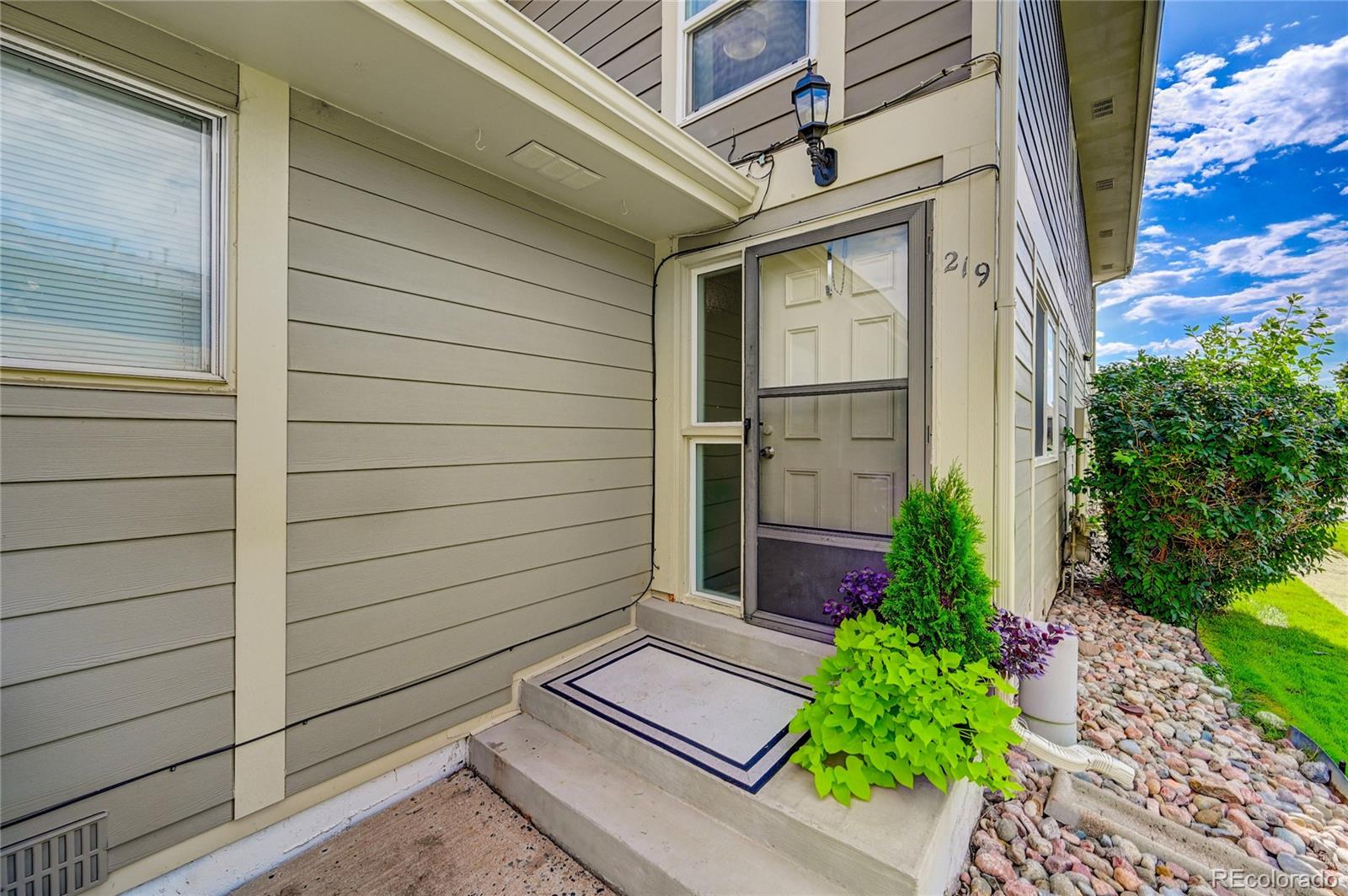 1225 South Oneida Street, Unit 219 Denver, CO 80224 - Photo 1 of 25 a view of a pathway besides a house