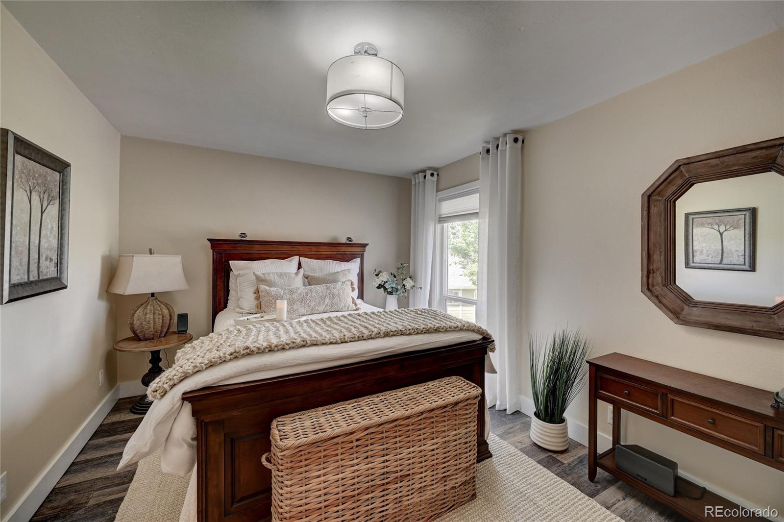 1225 South Oneida Street, Unit 219 Denver, CO 80224 - Photo 14 of 25 a bedroom with a bed and a chandelier