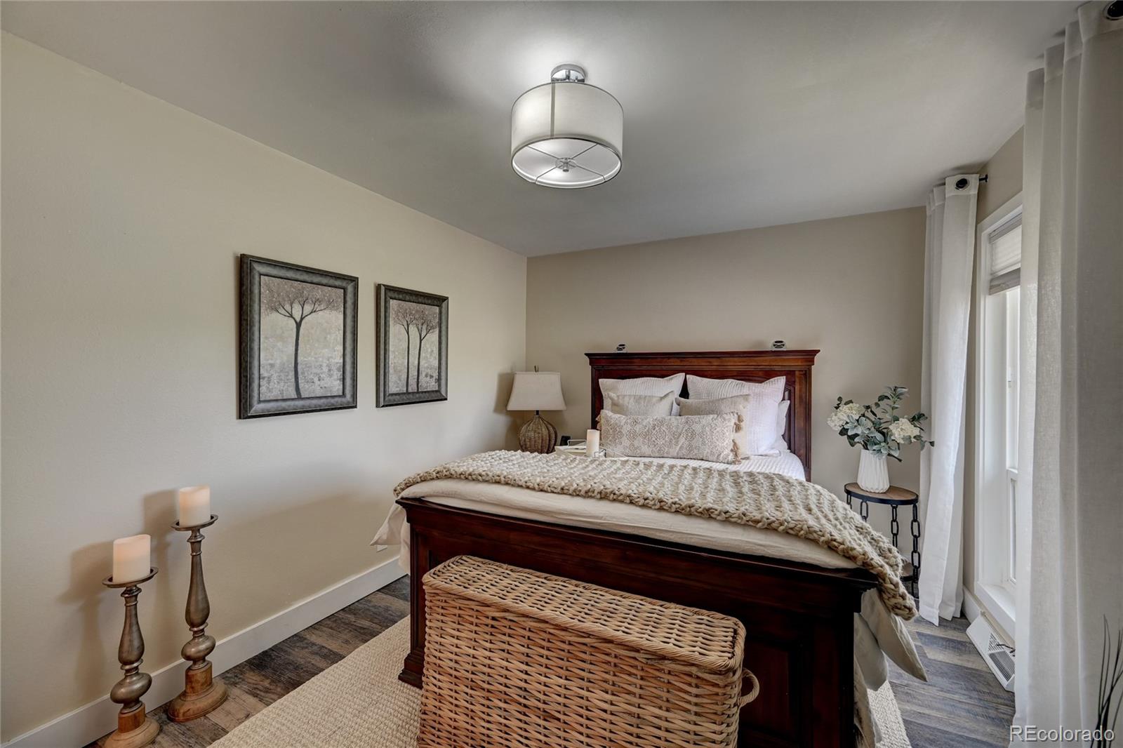 1225 South Oneida Street, Unit 219 Denver, CO 80224 - Photo 15 of 25 a bedroom with a bed and a lamp