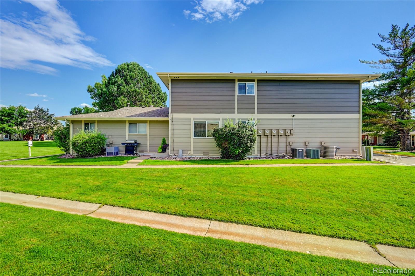 1225 South Oneida Street, Unit 219 Denver, CO 80224 - Photo 21 of 25 a front view of a house with a yard