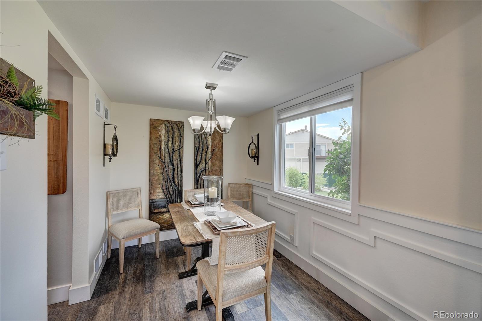 1225 South Oneida Street, Unit 219 Denver, CO 80224 - Photo 7 of 25 a view of a dining room with furniture window and wooden floor