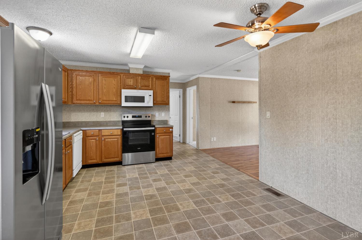 1811 Mohawk Road Gladys, VA 24554 - Photo 16 of 51 a kitchen with granite countertop a stove a sink and a refrigerator