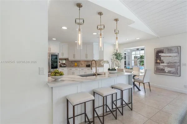 a large kitchen with a table and chairs