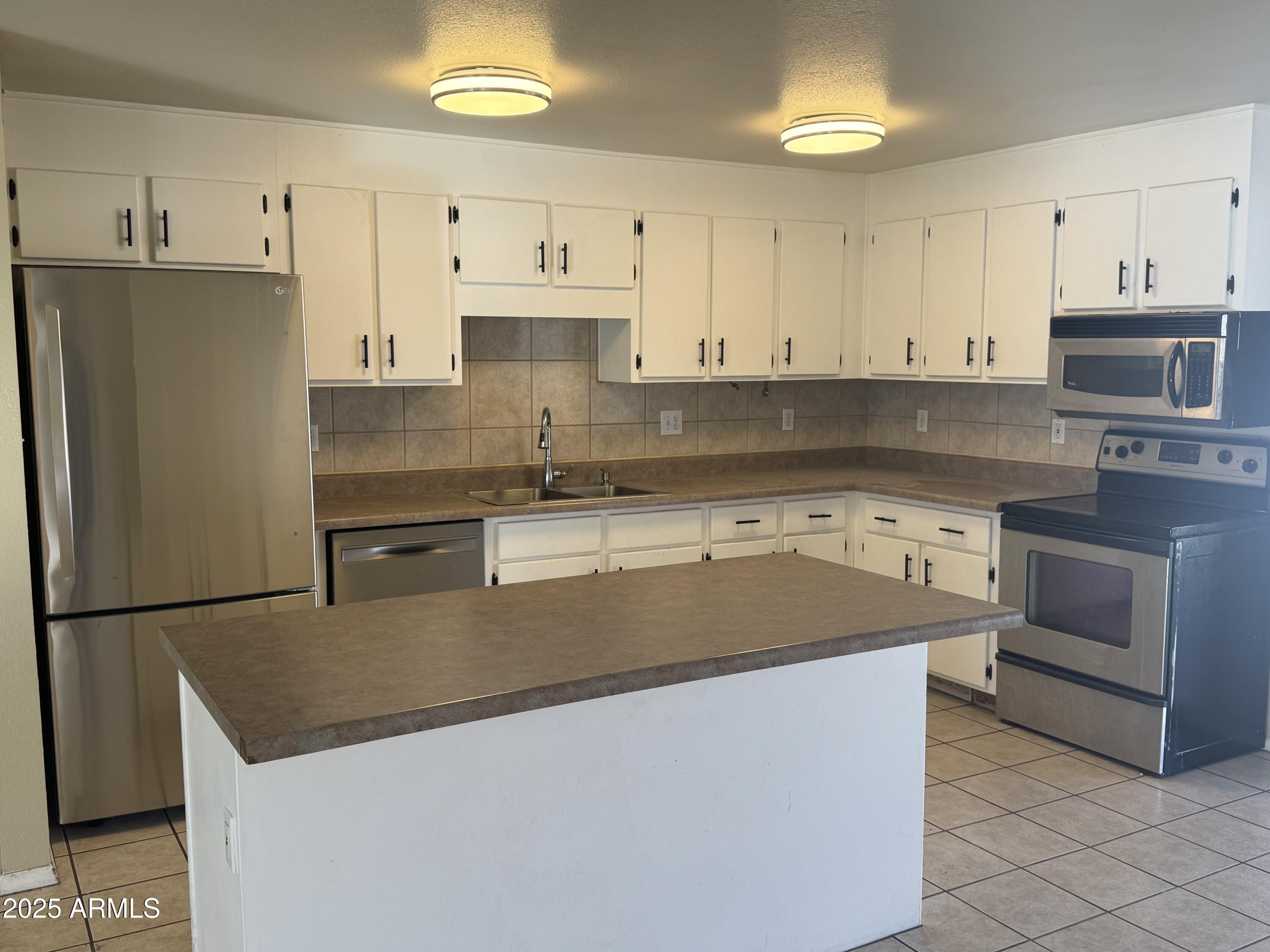 4016 East Eugie Avenue Phoenix, AZ 85032 - Photo 2 of 8 a kitchen with stainless steel appliances granite countertop a sink stove and refrigerator