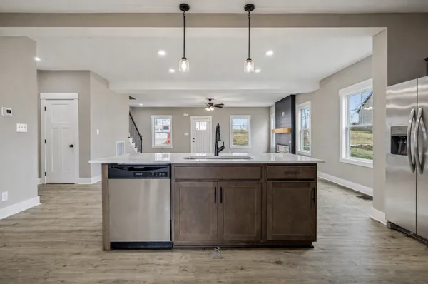 a kitchen with counter top space sink and refrigerator