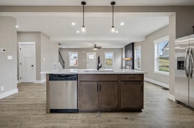 a kitchen with counter top space sink and refrigerator
