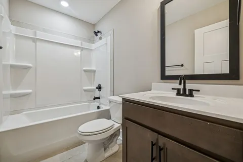 a bathroom with a sink a toilet and a bathtub