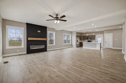 a view of living room with furniture and a ceiling fan