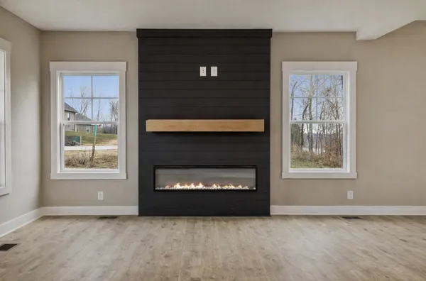 a living room with a fireplace and a window