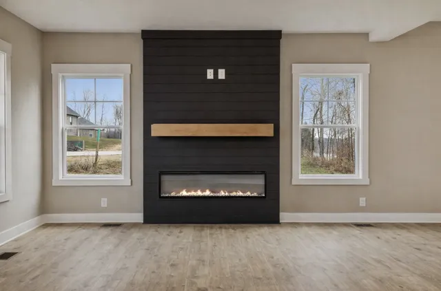 a living room with a fireplace and a window