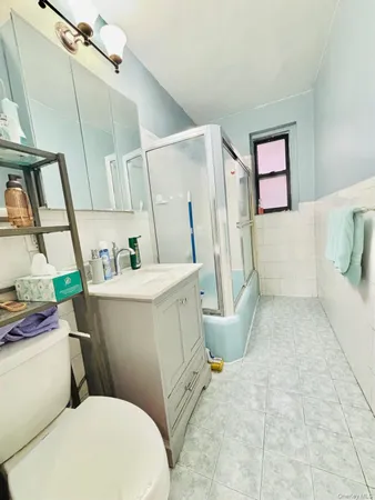 a white toilet sitting next to a bathroom sink and a tub