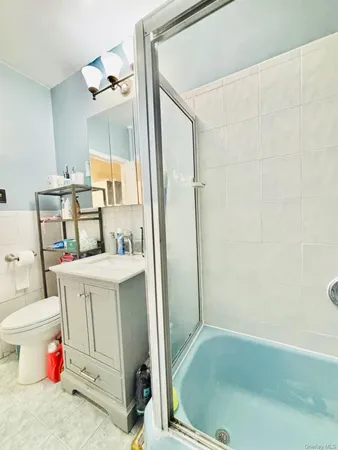 a bathroom with a tub sink and a mirror