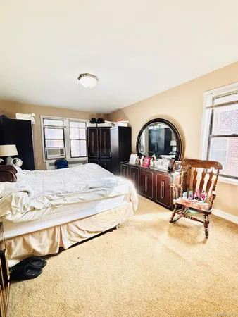 a living room with furniture a flat screen tv and a stove