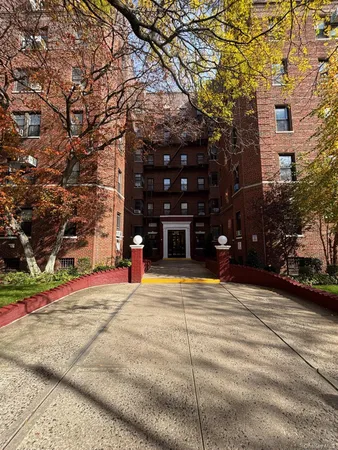 a tall building with trees in front of it