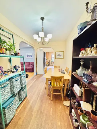 a view of a dining room with furniture a rug and wooden floor
