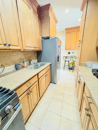 a kitchen with stainless steel appliances a sink stove and cabinets