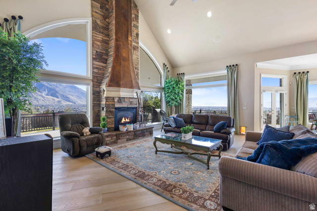 684 North Summit Way Alpine, UT 84004 - Photo 24 of 58 Living area featuring vaulted ceiling, light wood finished floors, recessed lighting, a fireplace, and a ceiling fan