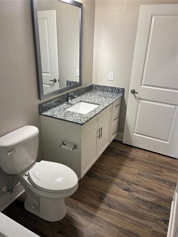 2115 Waterfall Ct Mount, Unit 8211 Mount Dora, FL 32757 - Photo 17 of 21 a bathroom with a granite countertop toilet and a sink