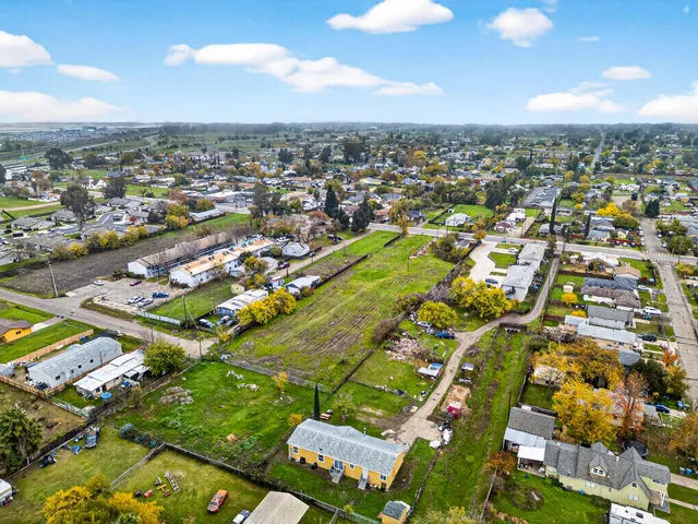 an aerial view of residential houses with outdoor space
