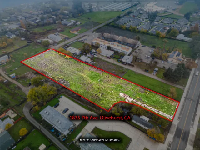 an aerial view of a tennis ground and a residential houses