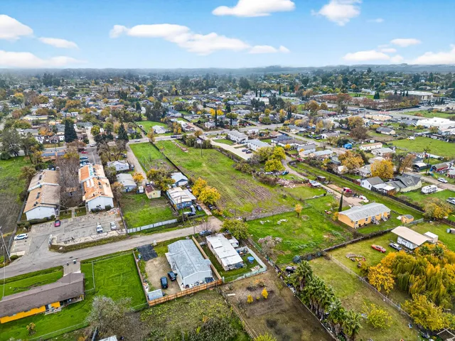 an aerial view of residential houses with outdoor space