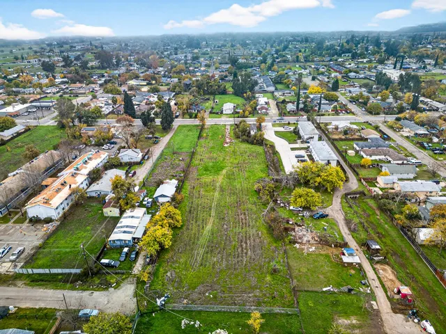 an aerial view of residential houses with outdoor space and pool