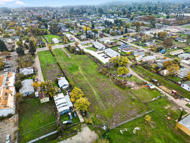 an aerial view of residential houses with outdoor space