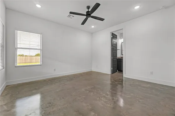 an empty room with closet and windows
