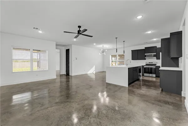 a large kitchen with cabinets and stainless steel appliances