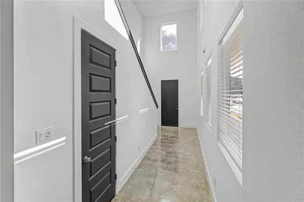 a view of a hallway with wooden floor and entryway