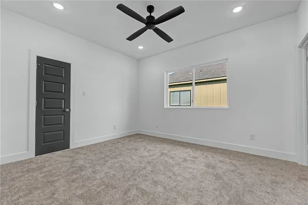 an empty room with closet and windows