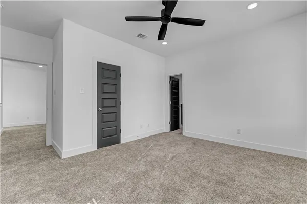 a view of an empty room with a ceiling fan