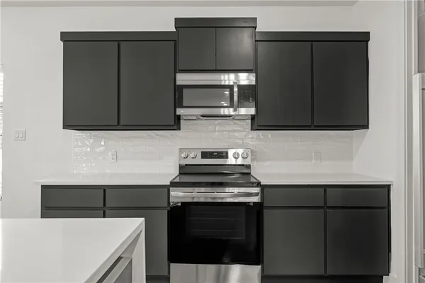 a kitchen with a stove and a microwave