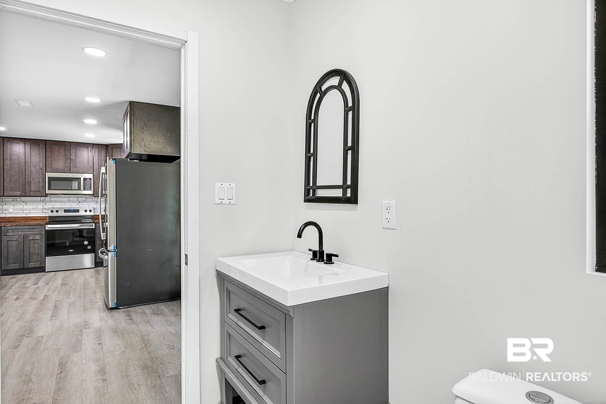 101 Terry Avenue Brewton, AL 36426 - Photo 41 of 48 Bathroom with backsplash, recessed lighting, vanity, and wood finished floors