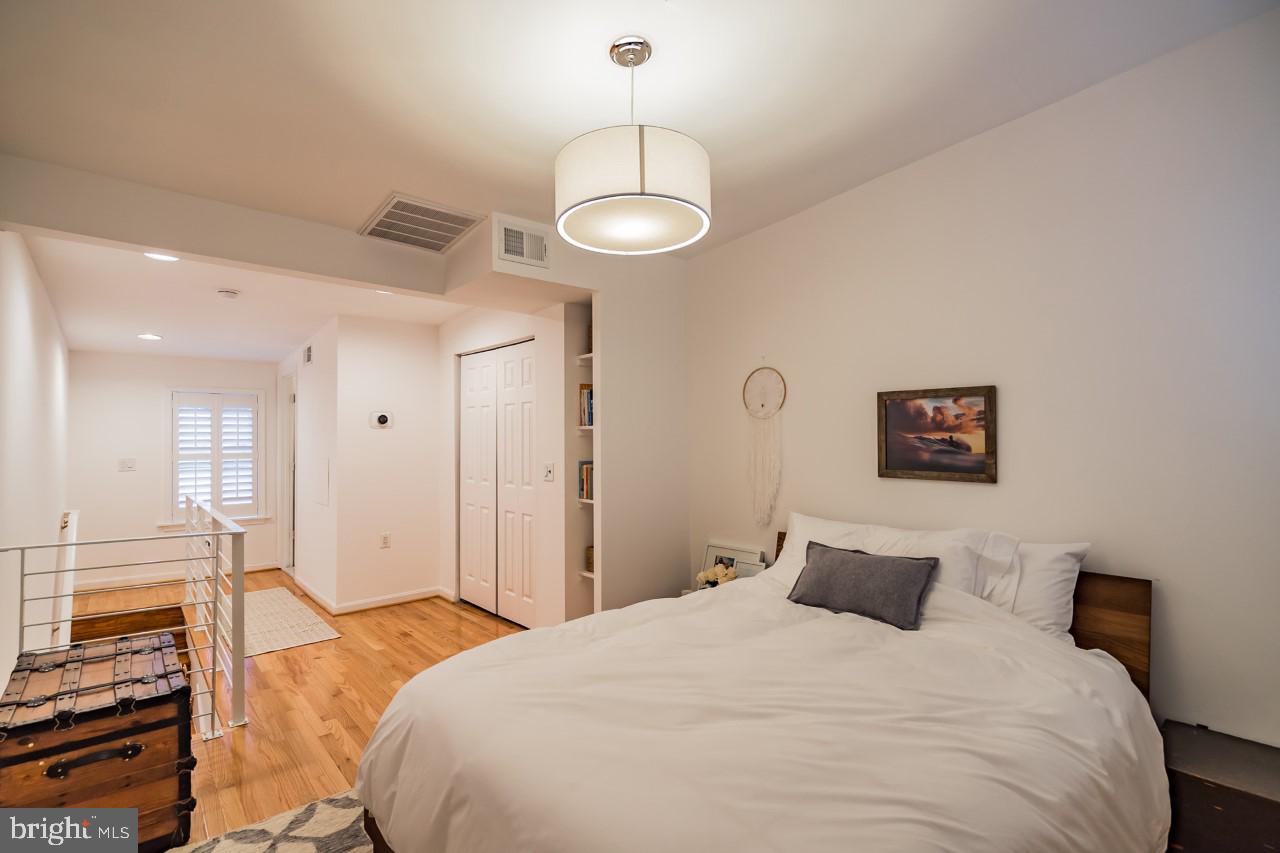619 11th Street Northeast Washington, DC 20002 - Photo 4 of 6 a bedroom with a bed and a chandelier