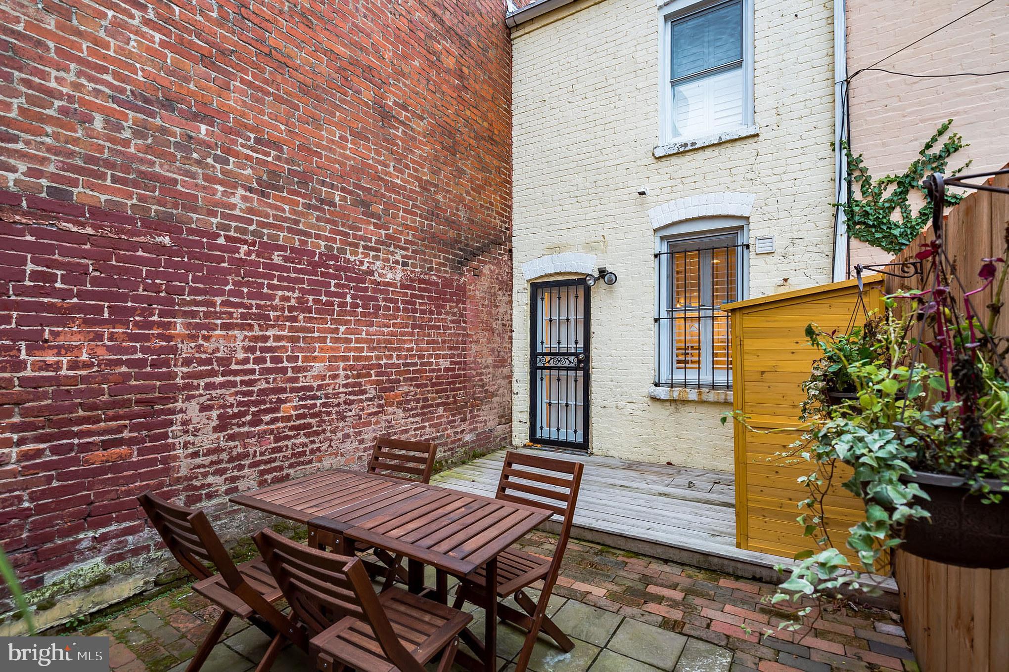 619 11th Street Northeast Washington, DC 20002 - Photo 6 of 6 a view of a patio with table and chairs with wooden floor and plants