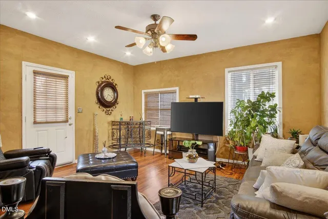 a kitchen with stainless steel appliances granite countertop a table chairs sink and cabinets
