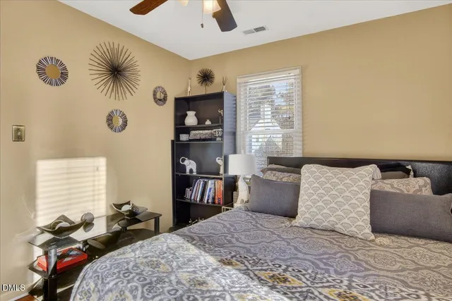 a bedroom with a bed and dresser with mirror