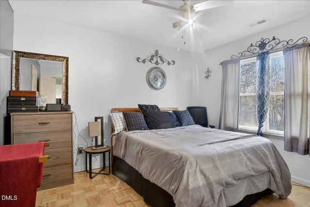 a bedroom with a bed and window