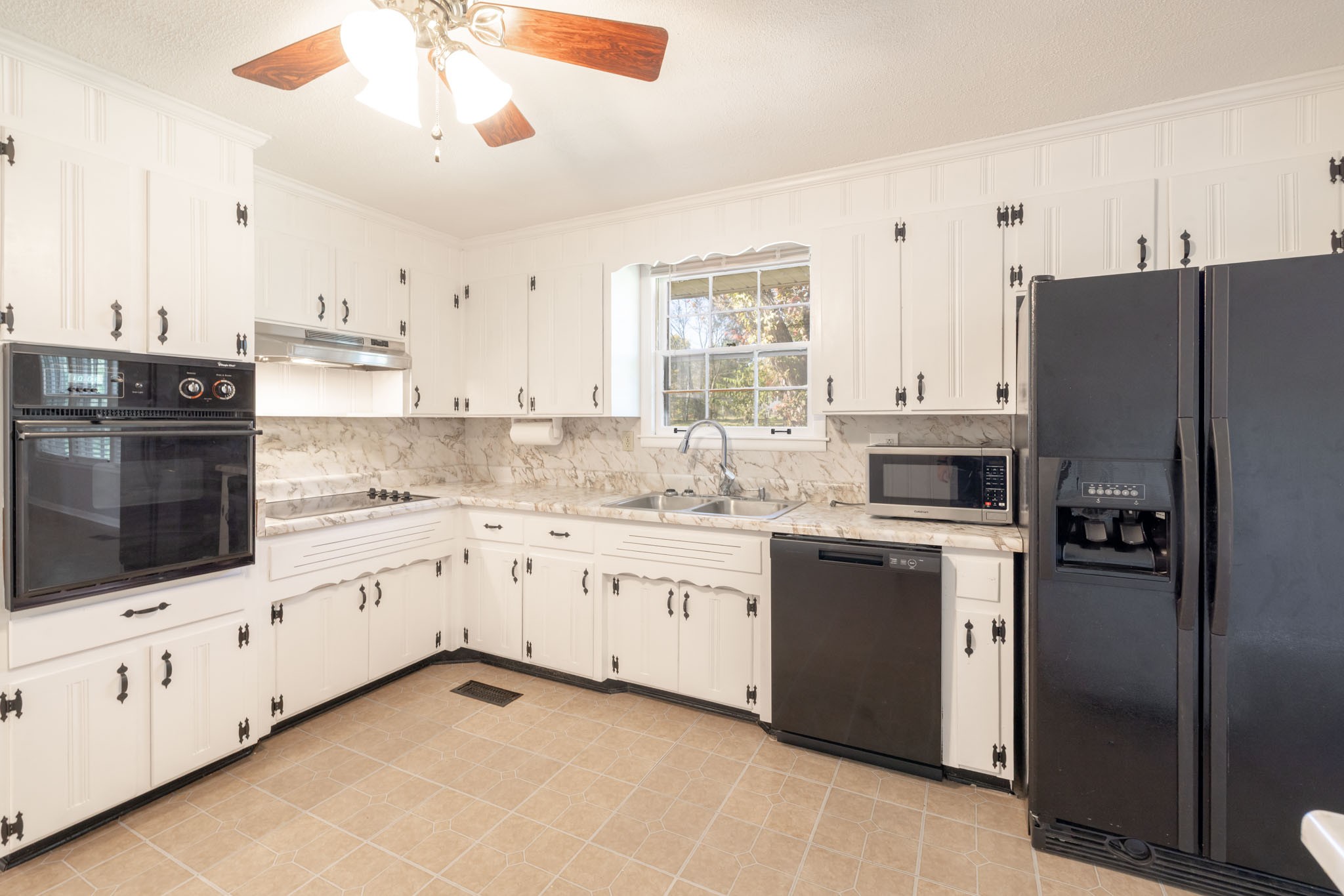 1015 Lockertsville Road Ashland City, TN 37015 - Photo 26 of 72 a kitchen with granite countertop white cabinets and stainless steel appliances