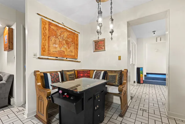 a view of a dining room with furniture and a chandelier