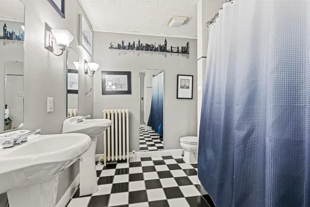 a spacious bathroom with a sink a mirror a vanity and a shower