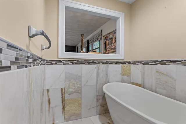 a bathroom with a bathtub and a window